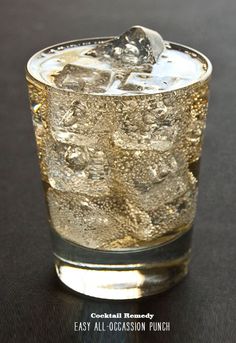 a glass filled with ice sitting on top of a table