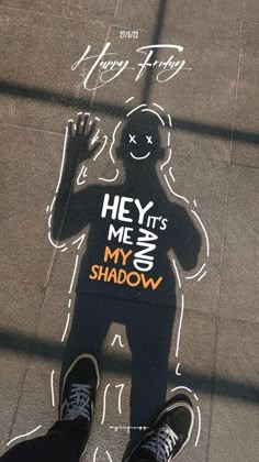 someone standing in front of a chalk drawing on the sidewalk that says hey it's me and my shadow