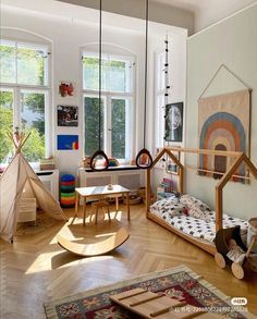 a living room filled with furniture and lots of window sill space next to a wooden floor