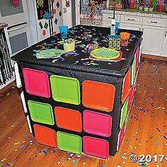 an image of a birthday party table in the middle of a room with confetti all over it