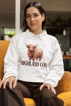 A Highland Coo Sweatshirt is the perfect companion for those crisp autumn days. Featuring an adorable highland cow design, this sweatshirt is as cosy as it is cute. Whether you're exploring the outdoors or simply snuggling up indoors, this soft pullover is a must-have for the season. Made with high-quality fabric, it's designed to keep you warm while celebrating Scotland's iconic Highland coo. The rustic charm of the design captures the essence of autumn, making it the ideal sweater for any fan Highland Coo, Cute Highland Cow, Cosy Autumn, Fall Apparel, Cow Design, Crisp Autumn, Scottish Gifts, Autumn Days, Scottish Heritage