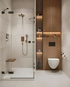 a bathroom with a toilet, shower and shelves on the wall next to each other