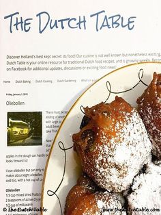 a white plate topped with powdered sugar covered pastries next to a recipe book