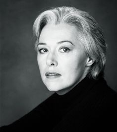 a black and white photo of a woman with blonde hair wearing a turtle neck sweater