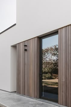 an exterior view of a modern house with wood cladding