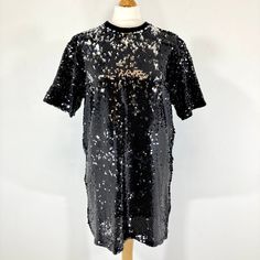 Beautiful mini dress by Fiorucci in a stunning black Sequinned fabric. This loose fitting dress is covered in black sequins that shimmer silver in the light. It has a has a ribbed neckline, like an oversized Tshirt.  In good condition. Measurements  Bust: 40" Length: 30" Sleeves: 9" Dress Midi Party, Black Sequined T-shirt For Summer, Black Mini Sequin Dress Party-ready, Cheap Cotton Sequined T-shirt, Black Sequin Short Sleeve T-shirt, Black Mini Sequin Fabric With Contrast, Vintage Faux Fur Coat, Beautiful Mini Dresses, Midi Party Dress