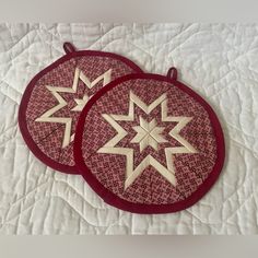 two red and white plates sitting on top of a bed