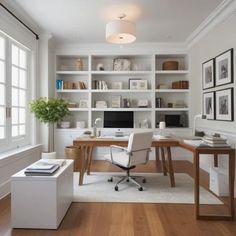 a home office with built in shelving and desk, along with white walls and wood flooring