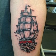 a tattoo on the arm of a man with a ship