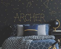 an image of a bedroom setting with black walls and gold stars on the back wall