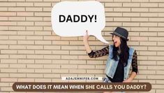 a woman holding up a speech bubble with the words daddy written on it in front of her