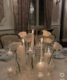 a table topped with lots of candles and flowers