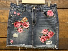 a denim skirt with flowers painted on it