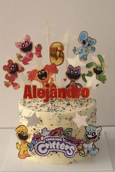 there is a birthday cake with many cartoon characters on it and the name aligando