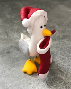 a toy chicken with a santa hat on its head