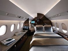 the inside of an airplane that has two beds and windows on each side of it