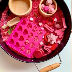 a bowl filled with lots of different types of candies and other candy decorations on top of a table