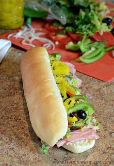 a long sub sandwich sitting on top of a counter