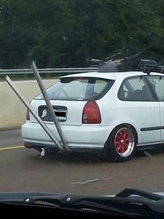 a white car with luggage strapped to it's roof