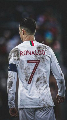 the back of a soccer player's shirt with dirt all over it