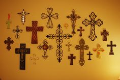 a wall with many different crosses on it