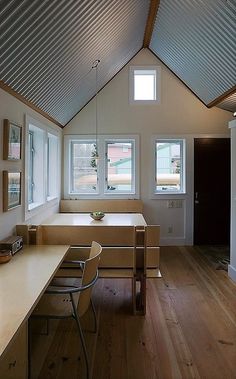 an empty room with wooden floors and white walls