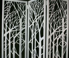 a room divider made out of white paper with trees cut in to the sides