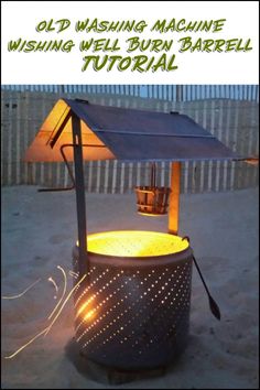 an outdoor stove with a solar panel on top and some lights in the sand around it