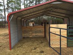 an enclosed area with metal fence and red roof