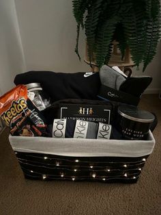 a basket filled with coffee and snacks on the floor