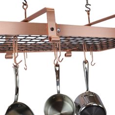 pots and pans are hanging from a rack with hooks on the bottom, while another pair of frying pans sits below them