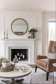 a living room filled with furniture and a fire place next to a mirror on the wall