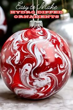 a red and white christmas ornament sitting on top of a marble countertop