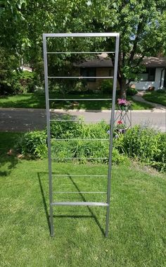 a metal rack sitting on top of a lush green field