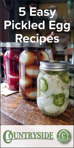 jars filled with pickled egg and cucumbers on top of a wooden table