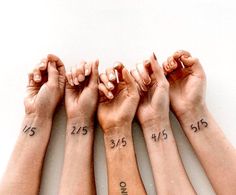 four hands holding each other with numbers on them