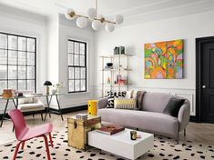 a living room filled with furniture and lots of windows