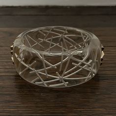 a glass bowl sitting on top of a wooden table