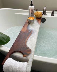 a bathtub with soap and candles in it