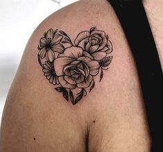 a heart shaped tattoo with flowers on it