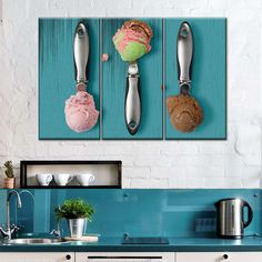 three kitchen utensils hanging on the wall