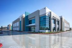 an empty parking lot in front of a large building