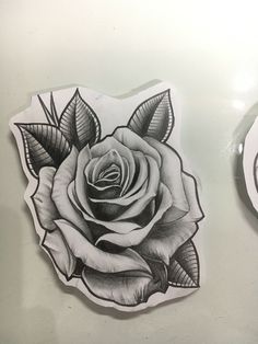 a drawing of a rose with leaves on it