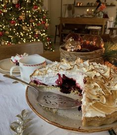 there is a pie on the table with christmas trees in the background and decorations around it