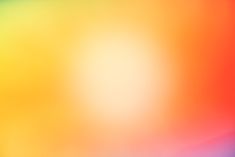 a blurry image of an orange, yellow and blue background with the colors of rainbow