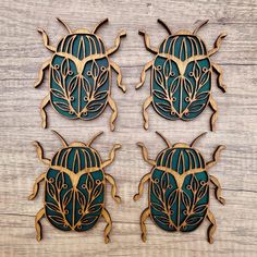 three wooden bugs with intricate designs on them