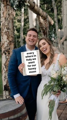 a bride and groom holding up a sign that says, every where in the world we want to be for our moon