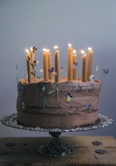 a chocolate cake with lit candles on it