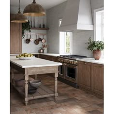 a kitchen with wooden cabinets and an island in front of the stove top, surrounded by hanging pots and pans