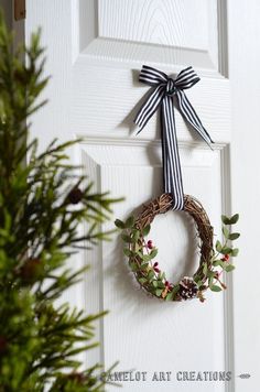 a white door with a wreath hanging on it